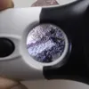 A close-up view of a textured surface seen through a magnifying glass. Náhled obrázku produktu