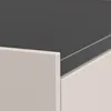 A close-up view of the corner of a cream-colored drawer or cabinet with a dark gray surface on top. Produktbild-Vorschau