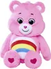 A pink Care Bear plush toy with a rainbow on its belly and hearts on its feet, sitting against a white background. Produktbild-Vorschau