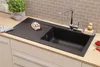 A black kitchen sink with a faucet and accessories on a wooden countertop. Produktbild-Vorschau