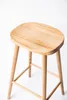 A wooden bar stool is shown against a white background. Produktbild-Vorschau