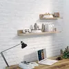 A home office setup with shelves displaying decorative items and books, a desk with a laptop and lamp. Produktbild-Vorschau