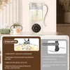 A close-up of a white multifunctional soy milk maker with a glass pitcher filled with milk, next to a baby bottle and a tissue box. The image also features close-ups of the blender blades and a different type of blade, with descriptive text in German. Voir les images du produit