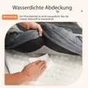 A hand is shown wiping a surface with a cloth, demonstrating water resistance. Produktbild-Vorschau