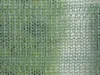 A close-up view of a green mesh fabric. Podgląd zdjęcia produktu
