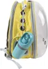 A yellow and clear pet carrier backpack with a blue water bottle attached. Produktbild-Vorschau