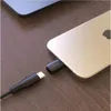 A close-up shot of a USB-C adapter being plugged into an iPhone, with a USB-C cable nearby. Produktbild-Vorschau