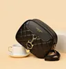 A black quilted handbag with a cat charm is placed next to a white teacup and saucer. Náhľad obrázku produktu
