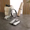 A collection of fitness equipment arranged on a floor, including a scale, yoga mat, resistance ring, headphones, and shoes. Produktbild-Vorschau