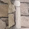 A close-up view of textured wallpaper designed to resemble a stone wall. Produktbild-Vorschau