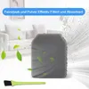 A foam filter and a small brush in front of a sofa, with animated leaves and dust particles. Produktbild-Vorschau