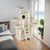 A cat tree is placed next to a bed in a room with a window overlooking the ocean. Náhled obrázku produktu