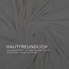 A close-up, swirled view of a cream-colored fabric, likely a blanket or textile, with overlaid text. Náhled obrázku produktu