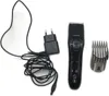 A black Philips hair clipper with its accessories, including a charging adapter and a comb attachment, laid out on a white background. Náhled obrázku produktu