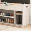 A white shoe cabinet with a padded seat on top, displaying various shoes on its shelves and boots in a separate compartment. Produktbild-Vorschau
