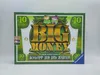 The image shows the front of a board game box, designed to resemble a banknote. Produktbild-Vorschau