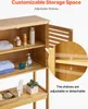 A close-up view of a wooden bathroom storage cabinet, showcasing its adjustable shelves and some toiletries. Náhled obrázku produktu