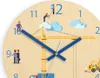 A close-up view of a children's wall clock with a construction theme. The clock face features numbers, hands, and cartoon illustrations of construction workers, a crane, clouds, and a toy excavator. Produktbild-Vorschau