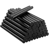 A pile of black hot glue sticks. Voir les images du produit