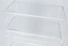 Close-up view of clear glass shelves inside a refrigerator, with "Safety Glass" printed on each shelf. Produktbild-Vorschau