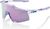 A pair of clear, transparent sports sunglasses with purple and pink mirrored lenses and purple accents on the temples, set against a white background. Náhled obrázku produktu