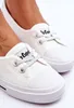 Close-up shot of white women's sneakers. Voir les images du produit
