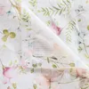 A close-up view of a folded textile with a floral pattern. Produktbild-Vorschau
