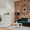 A living room scene with a white dresser, a green sofa, a coffee table, and a large wall clock. Produktbild-Vorschau