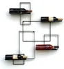 A black metal wine rack mounted on a white wall, holding four bottles of wine. Podgląd zdjęcia produktu