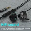 Close-up of black earphones and their audio jack on a textured gray surface. Produktbild-Vorschau