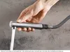 A hand holding a faucet sprayer with water running. Produktbild-Vorschau