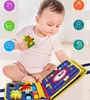 A baby is playing with a sensory book. Produktbild-Vorschau