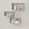 Three rectangular shelves are mounted on a textured gray wall, each displaying decorative items. Produktbild-Vorschau