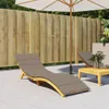 An outdoor patio scene with lounge chairs and a wooden fence. Produktbild-Vorschau