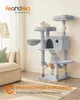 A cat tree in a living room setting with a sofa and lamp. Produktbild-Vorschau