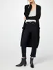 A woman modeling a long black cardigan over a light-colored top and dark jeans. Produktbild-Vorschau
