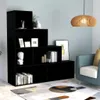 A black bookshelf filled with books, a bust, and decorative items, placed in a room next to a blue armchair. Podgląd zdjęcia produktu