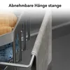 A close-up of a sink organizer with sponges and a towel hanging on a rack. Produktbild-Vorschau