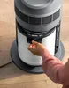 A person's hand is shown replacing a filter in an air purifier. Podgląd zdjęcia produktu