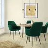A dining set with four dark green velvet chairs around a round marble-topped table with black metal legs, in a room with cream walls and light wood flooring. Náhled obrázku produktu