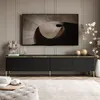 A modern living room with a TV stand and a large television. Produktbild-Vorschau
