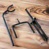 Three black metal guitar stands are laid out on a wooden surface. Náhľad obrázku produktu