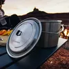 A camping scene with cooking equipment and a sunset in the background. Produktbild-Vorschau