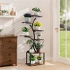A multi-tiered plant stand with various potted plants is placed next to a wooden dresser, with a large window showing a garden view in the background. Produktbild-Vorschau