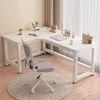 A white L-shaped desk with a gray office chair in front of it, set up in a room with light beige walls and white curtains. Produktbild-Vorschau