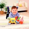 A young boy is lying on the floor with several Spongebob Squarepants plush toys. Anteprima dell’immagine prodotto