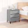 A gray wooden sideboard with three drawers is placed next to a bed in a bedroom. Produktbild-Vorschau