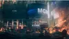 A destroyed city scene with a large building featuring an MGM logo and a digital display showing stock market information. Podgląd zdjęcia produktu