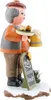 A wooden figurine of a man holding a plate of food and a mug of beer, standing on a snowy base with a chalkboard sign. Produktbild-Vorschau