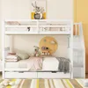 A white bunk bed with storage drawers and a staircase, decorated with children's items. Anteprima dell’immagine prodotto